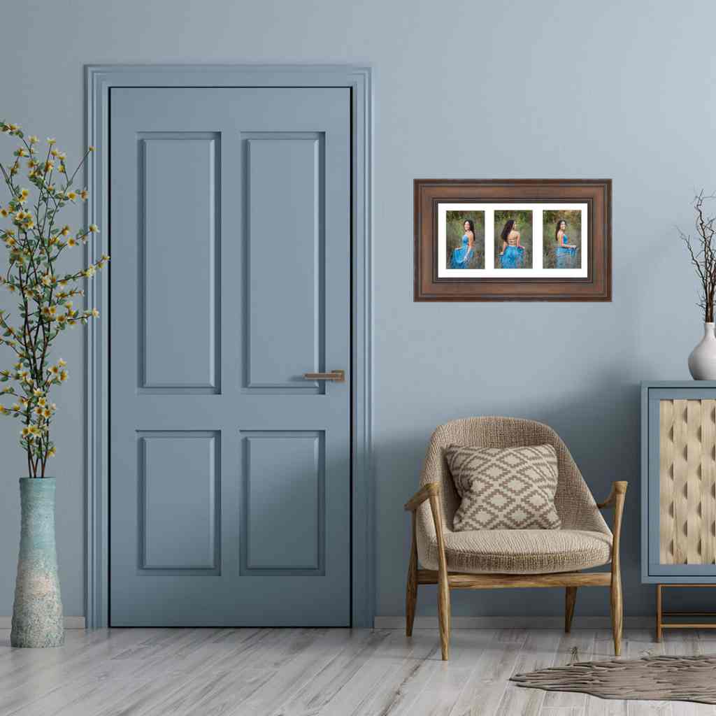 Cozy room with blue door, framed triple portrait on wall, patterned chair with cushion, floral vase, and a cabinet, creating a serene mood.